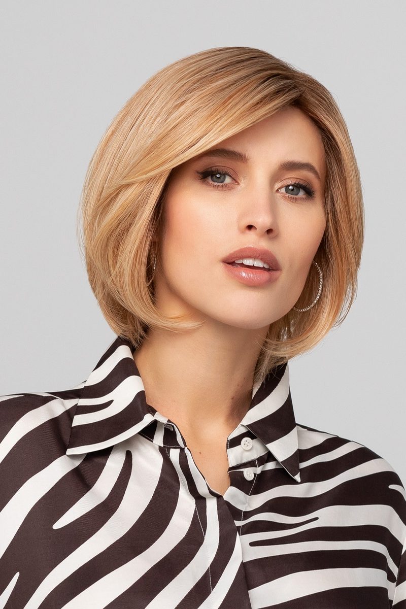a woman with blonde hair wearing a zebra shirt